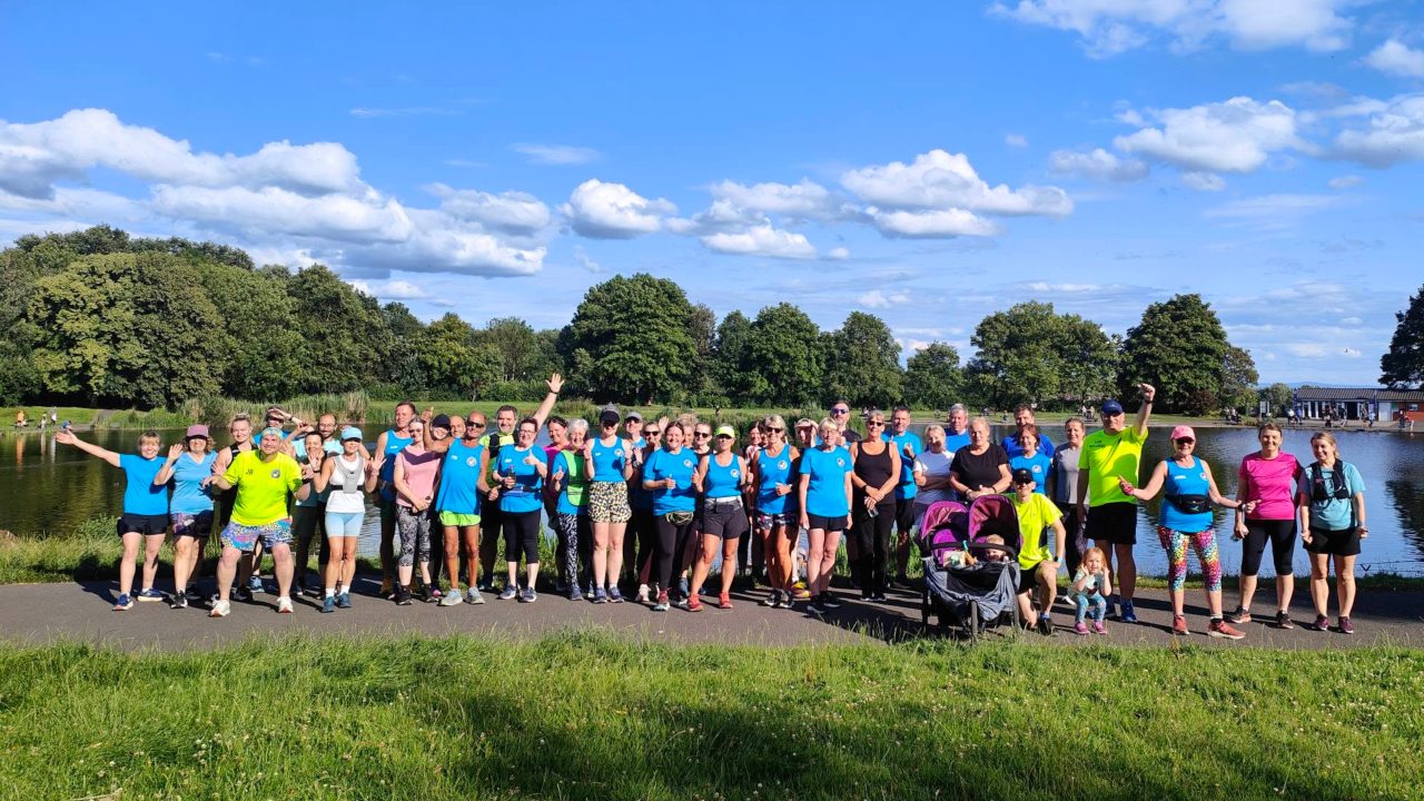 Clarence Runners members gathered by the water